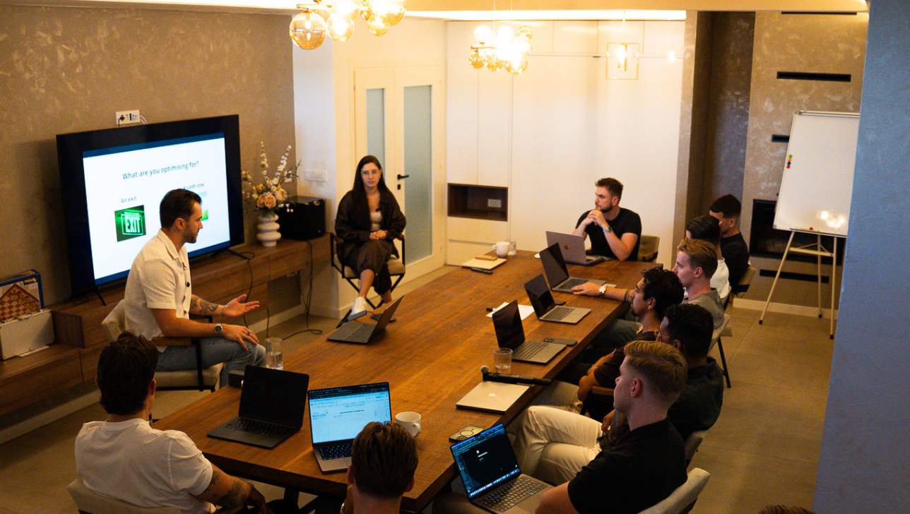 Romans Ivanovs and Kristina running a session at the BGG Agency Mastermind, working through team structure with the cohort.